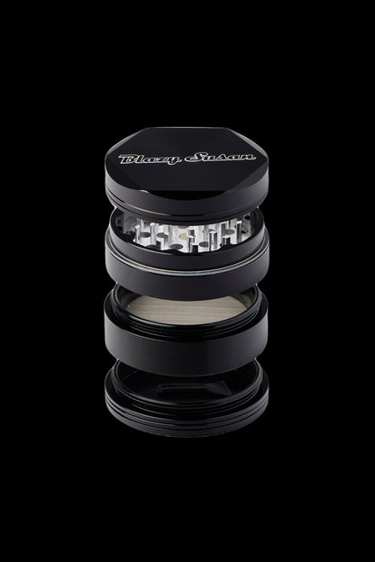Black four-piece grinder with “Blazy Susan” logo, partially disassembled to show internal components.