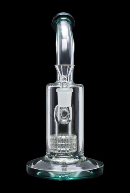 Clear glass bubbler with intricate perc filtration system, isolated on a black background.