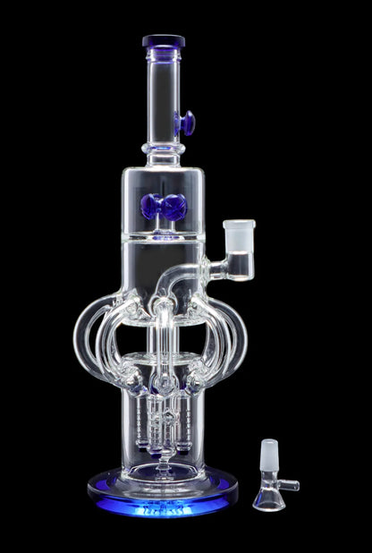Clear glass water pipe (bong) with blue accents and complex percolators, displayed with a glass bowl.