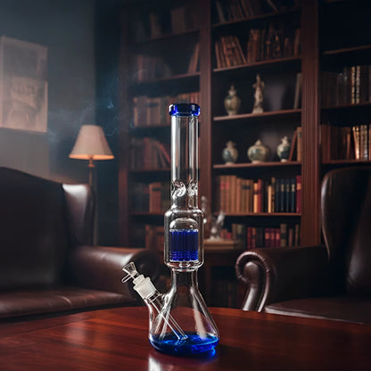 Centered front view of the Smoke Cartel 9mm Beaker w/ Tree Perc Bong - 18 in., clear glass with blue accents on a wooden table.