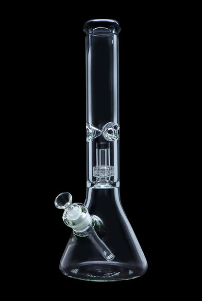 Clear glass bong with intricate perc filtration system, studio shot on black background.