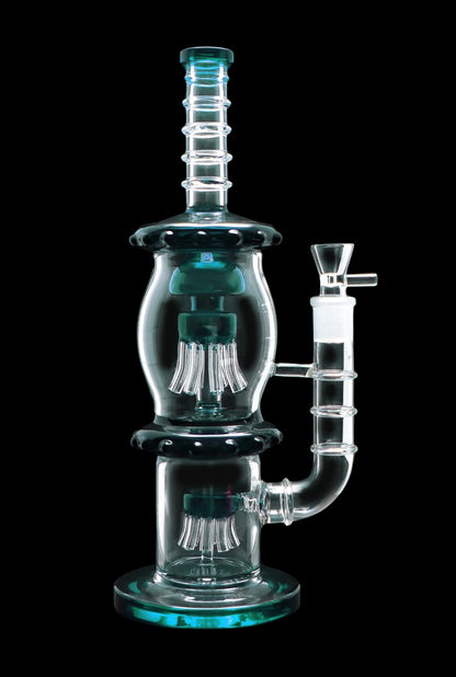 A studio shot of the 13.5-inch Smoke Cartel Straight Tube with Dual Octopus Perc, highlighting its clear glass construction and intricate perc design.
