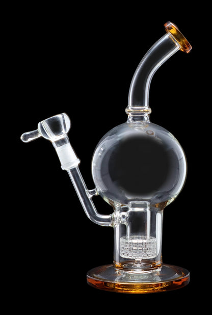 Angled studio shot of the Smoke Cartel Bent Neck Ball w/ Matrix Perc Bong - 10 in., clear glass with amber accents on a black background