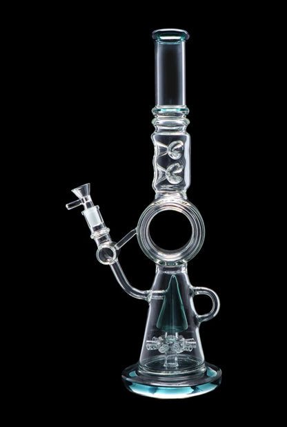 A clear glass water pipe (bong) with intricate designs and a blue tint, isolated on a black background.