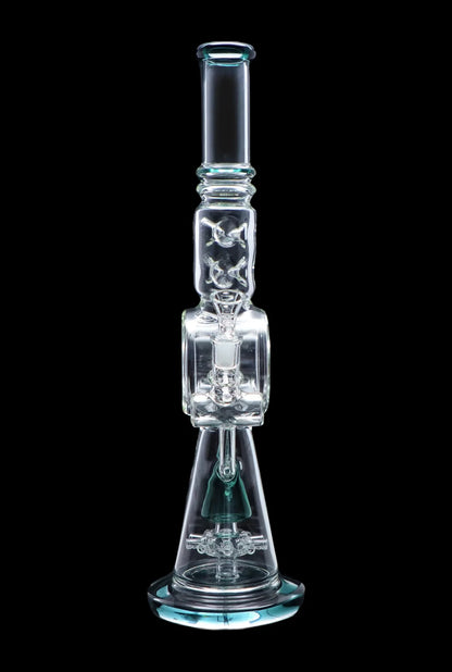 A clear glass water pipe (bong) with intricate percolators and a blue accent, isolated on a black background.