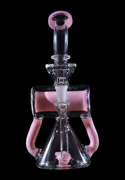 Pink glass water pipe (rig) with intricate design against a black background.