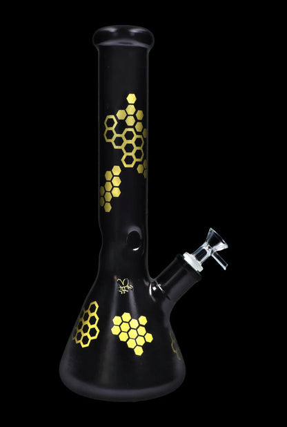 Black glass bong with gold honeycomb pattern.