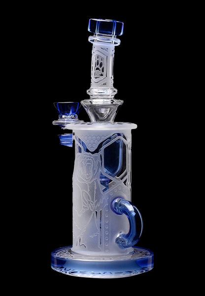 Frosted glass water pipe (bong) with blue accents and intricate geometric designs, isolated on a black background.