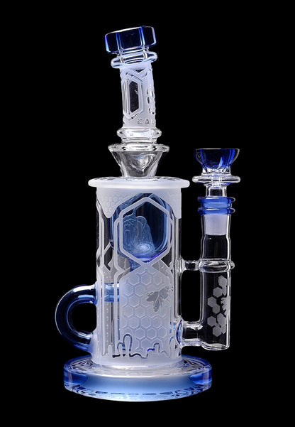 A detailed glass water pipe (bong) with a honeycomb pattern and blue accents, isolated on a black background.