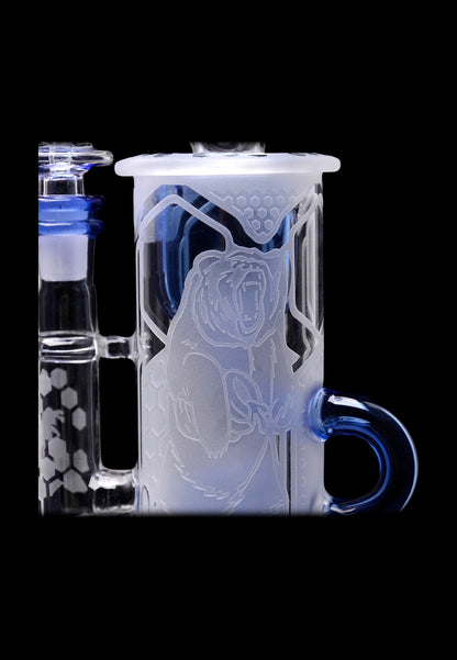 Blue and white glass bong with intricate bear design.