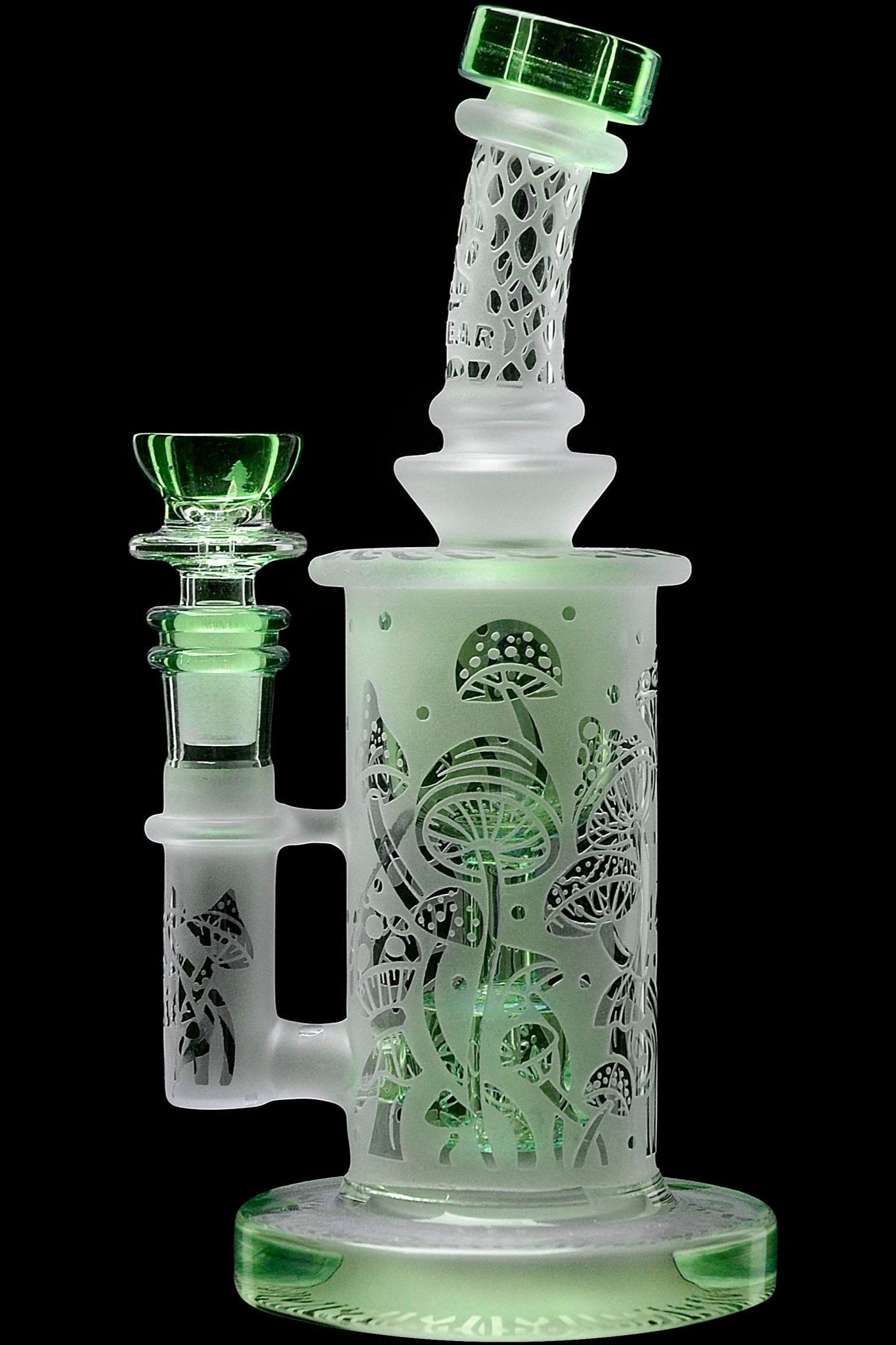 Frosted glass water pipe (bong) with intricate mushroom-themed etchings, illuminated with a green glow.