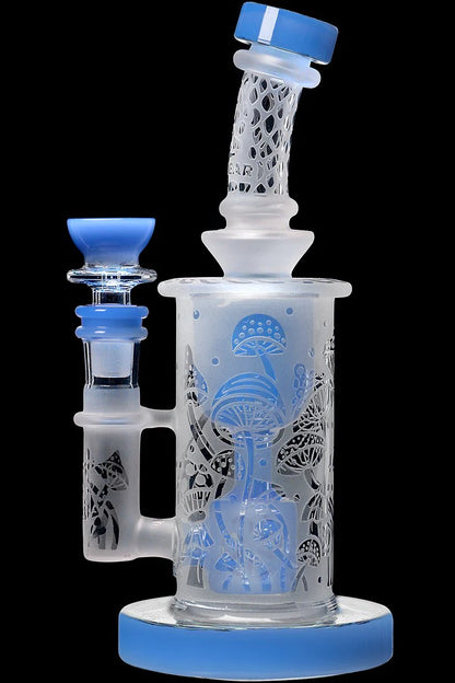 Clear glass water pipe (bong) with intricate mushroom etchings and blue accents.
