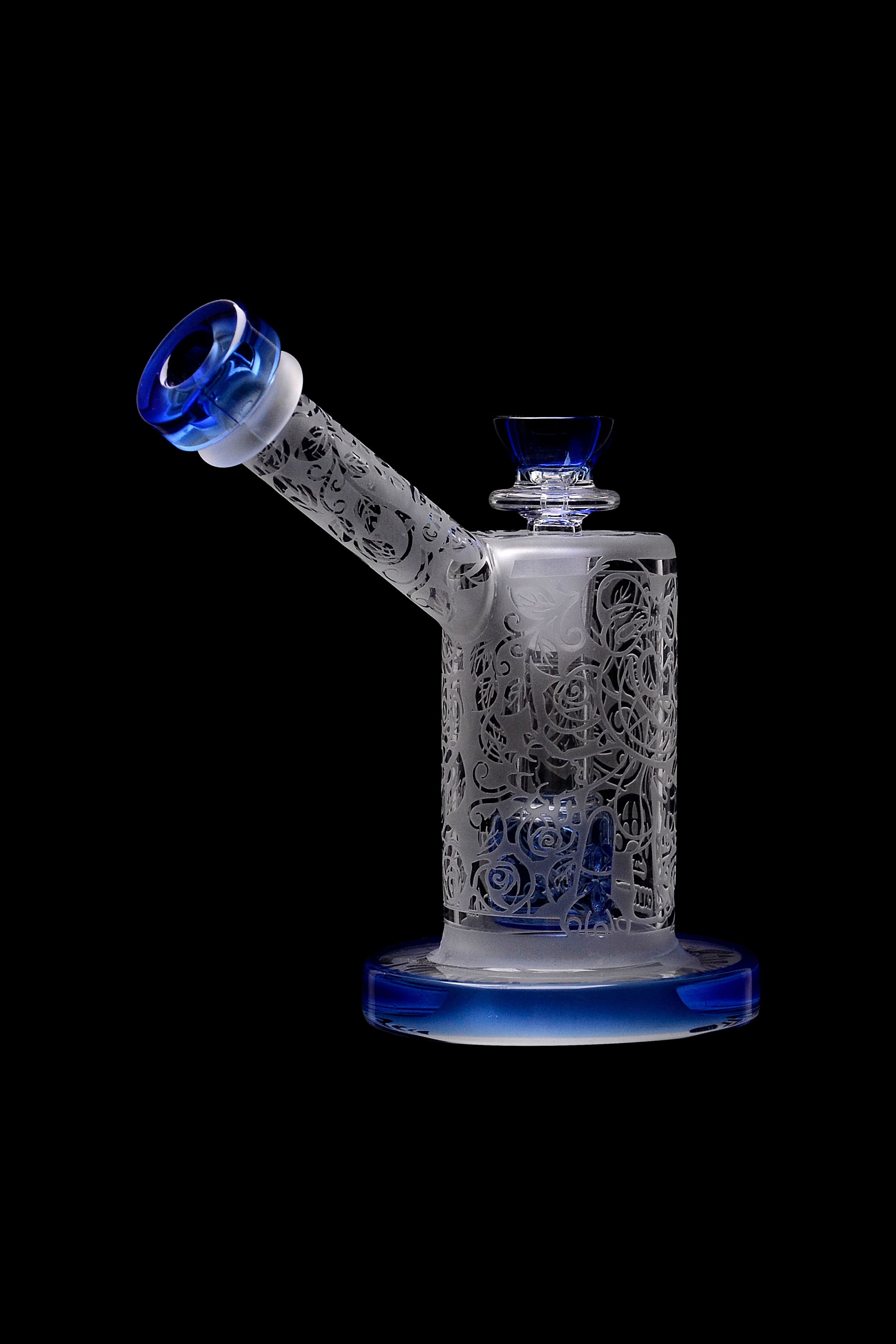 Frosted glass water pipe (rig) with intricate floral patterns and blue accents, isolated on a black background.