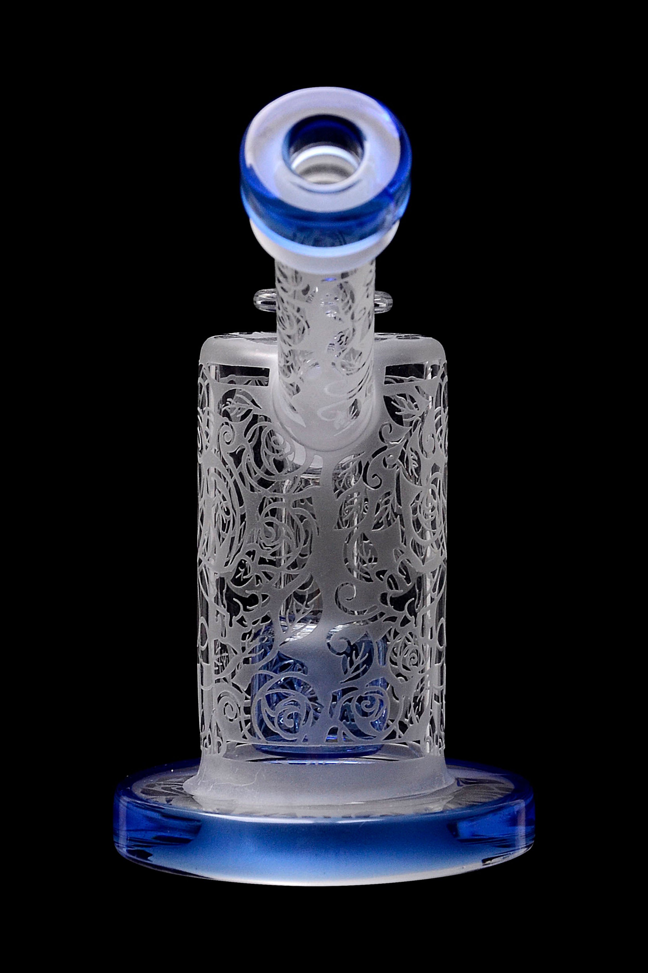 Intricate glass water pipe with floral latticework and blue accents, isolated on black.