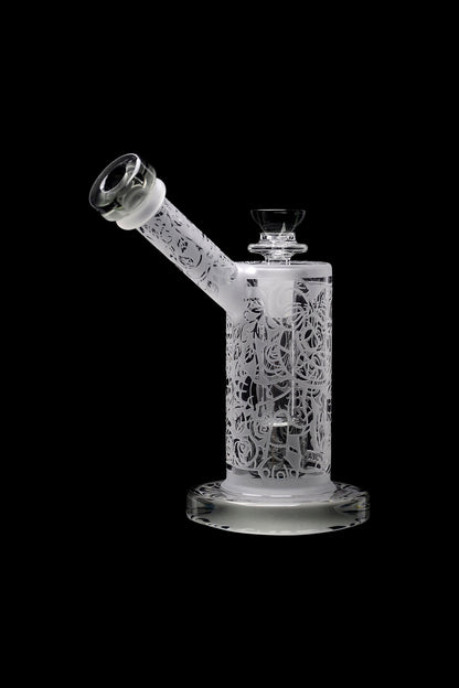 Frosted glass water pipe with sculpted skull and floral design.