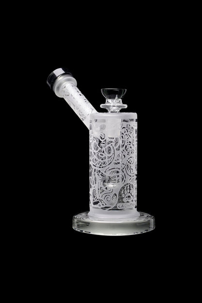Frosted glass water pipe (rig) with intricate floral carvings, isolated on black.