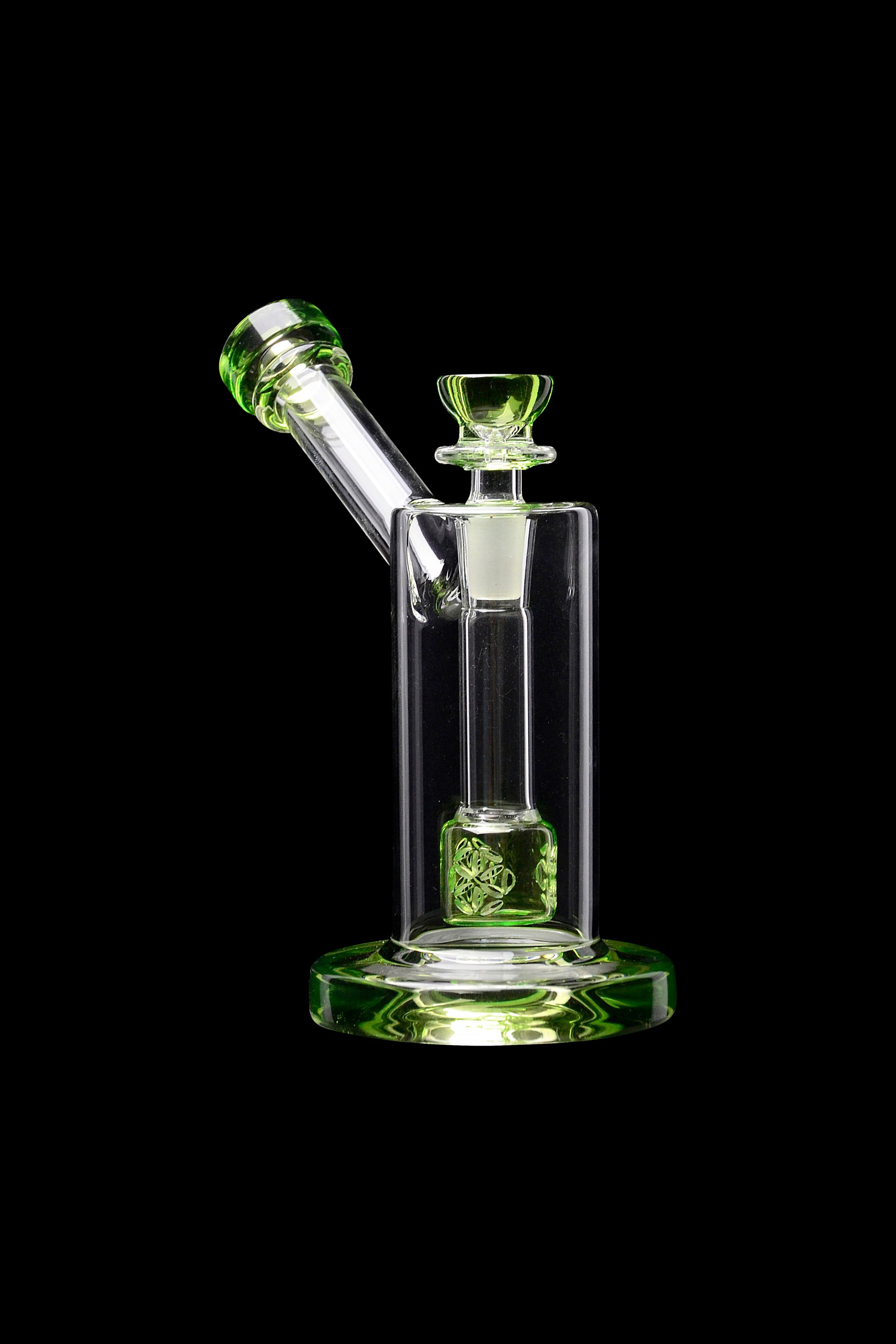 Green glass rig with intricate perc diffusion for cannabis concentrate use.