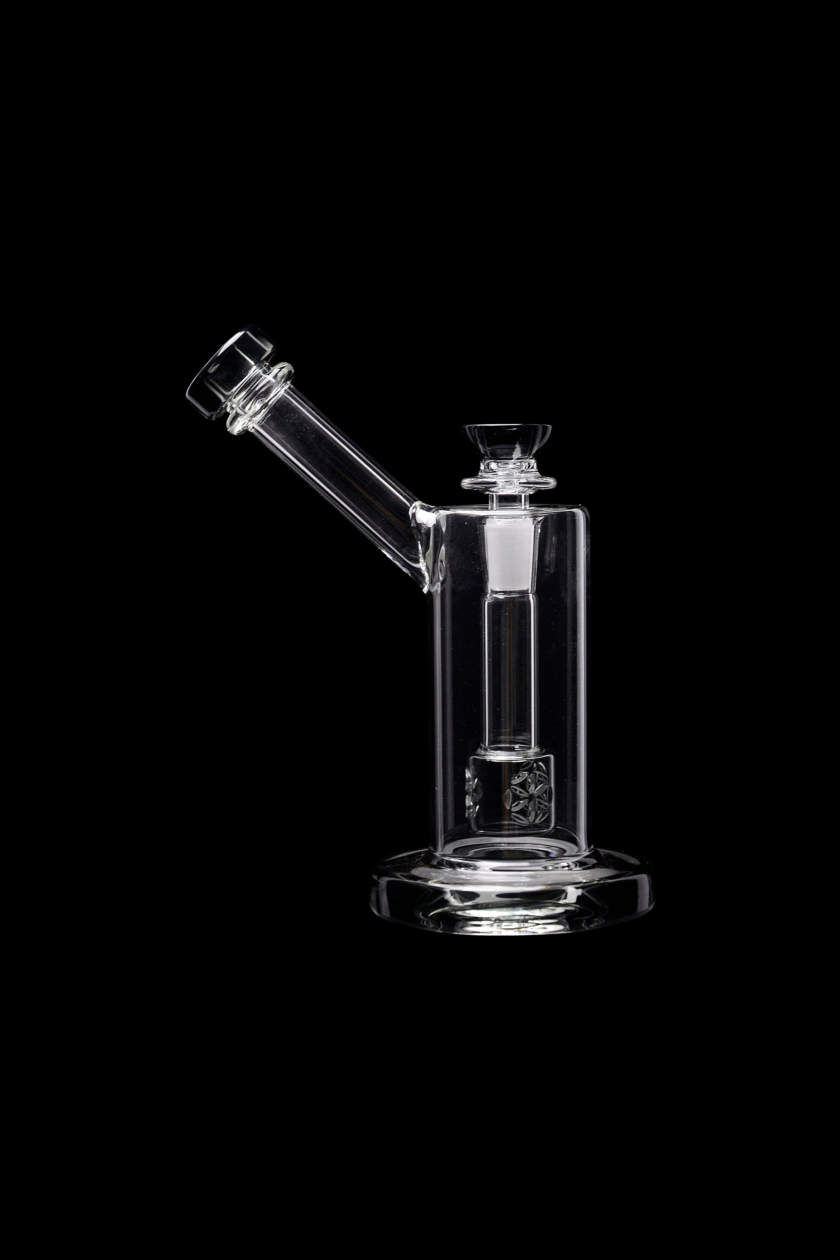 Clear glass dab rig with intricate percolator, isolated on black.