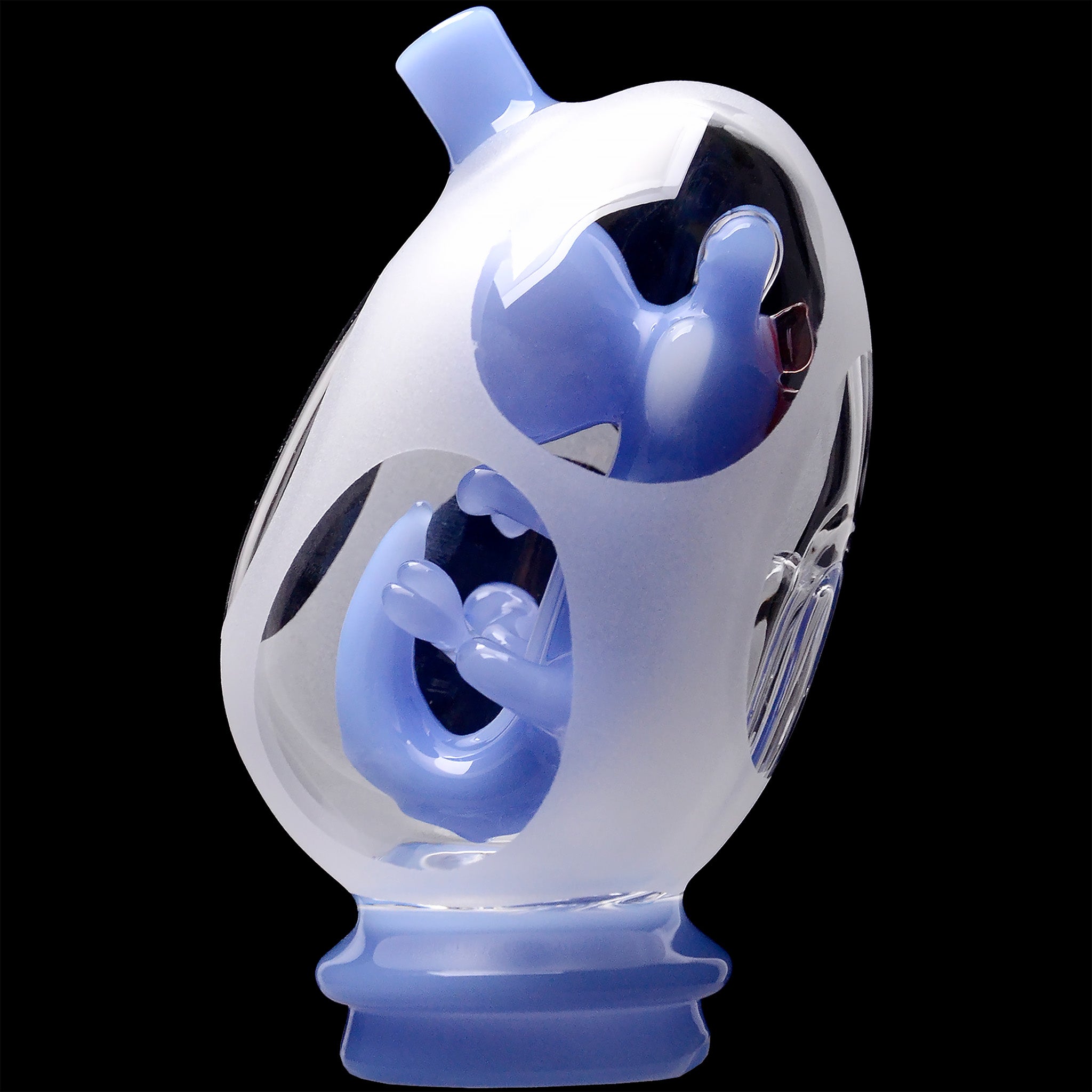 Close-up angled view of the Glassic Frosted Dino Egg Puffco Peak Glass Attachment showing frosted outer glass with glossy pale blue inner sculpted details against a black background
