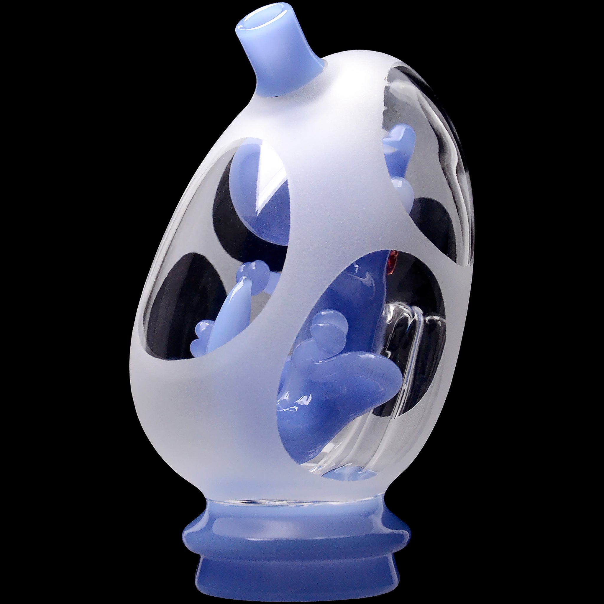 Close-up angled view of the Glassic Frosted Dino Egg Puffco Peak Glass Attachment showing frosted outer glass with glossy pale-blue interior spikes against a black background