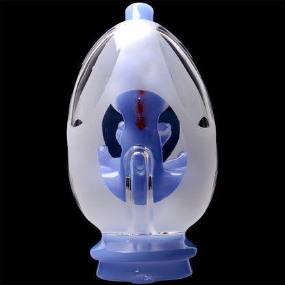 Close-up front view of the Glassic Frosted Dino Egg Puffco Peak Glass Attachment showing a frosted oval shell and blue inner dino sculpture against a black background