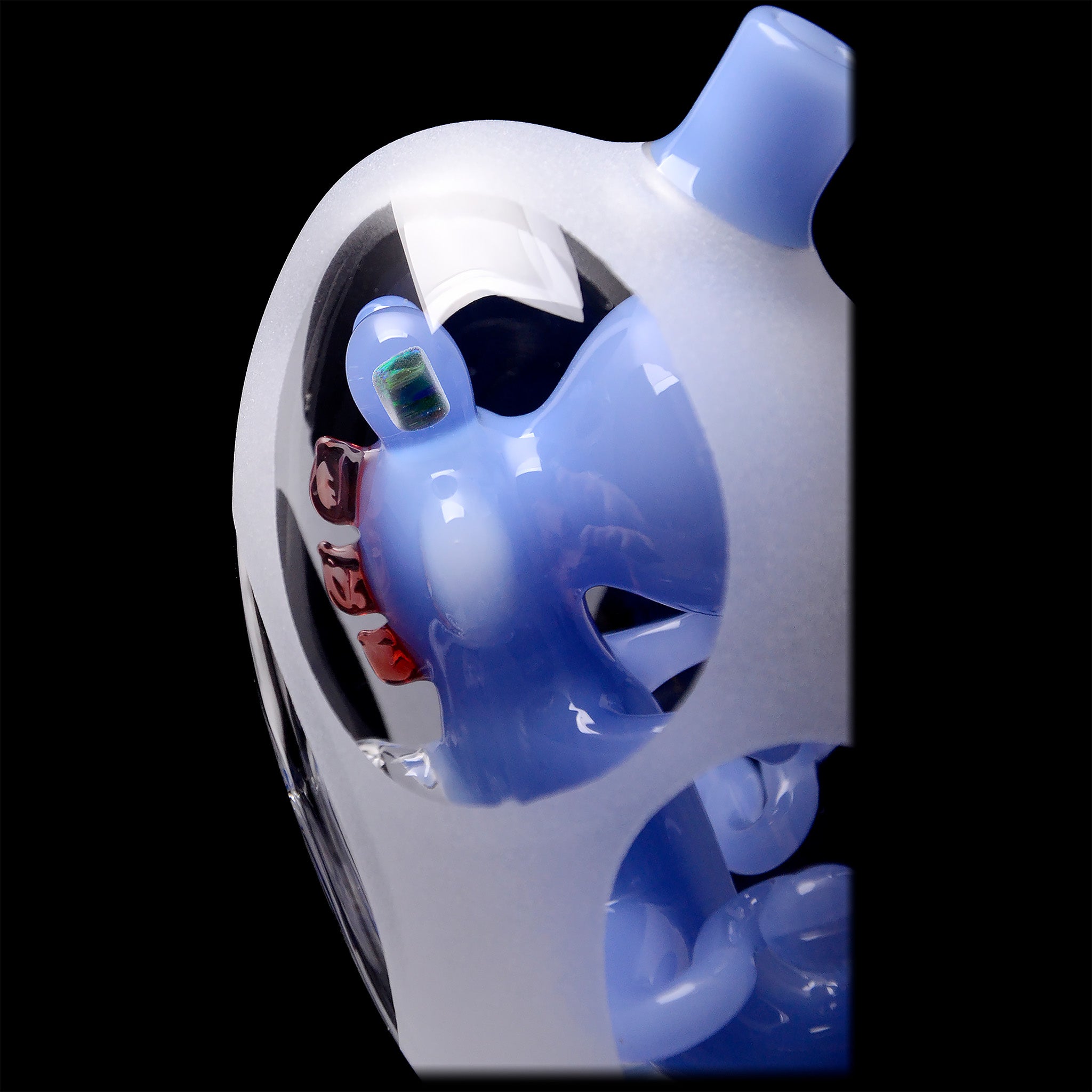 Close-up angled view of the Glassic Frosted Dino Egg Puffco Peak Glass Attachment showing frosted white rim and glossy pale blue sculpted glass details against a black background