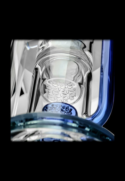 Close-up of a glass bong with a honeycomb diffuser and blue accents.