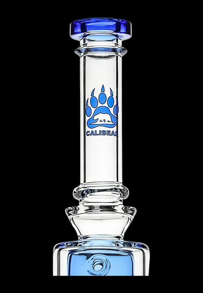 Clear glass water pipe (bong) with blue accents and a bear logo.