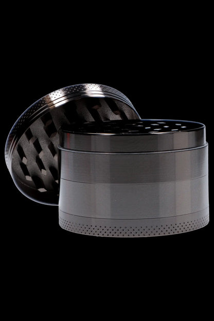 Metallic four-chamber cannabis grinder with open lid.