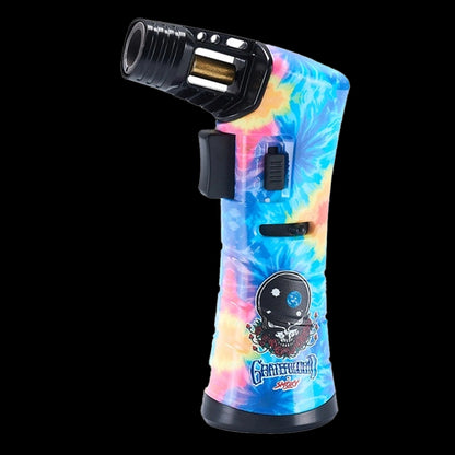 Angled close-up of the blue tie-dye Grateful Dead Freedom Torch showing its black nozzle, trigger, and skull artwork.
