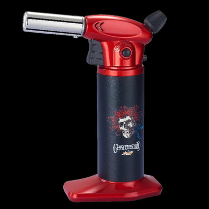 Close-up front view of the Grateful Dead Vulcan Torch showing its red metal top, black body with skull graphic, and angled chrome nozzle.