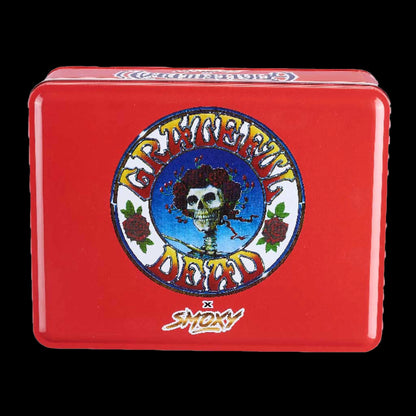 Top-front view of a red Grateful Dead Dragon Torch tin showing a centered circular skull-and-roses logo and glossy rounded edges.