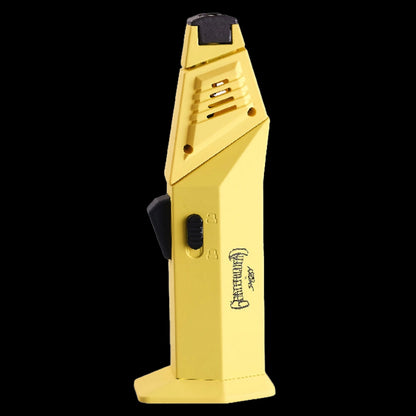 Angled close-up of the yellow Grateful Dead Flex Torch showing its textured ignition tip, side lock slider, and hexagonal base against a black background