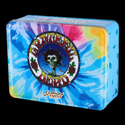 Angled close-up of the blue tie-dye tin featuring the Grateful Dead Flex Torch logo with a skeleton face wreath on the lid.