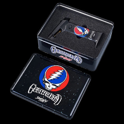 Angled top view of the Grateful Dead The Rock Torch nestled in foam inside its black tin lid printed with the band's skull logo.