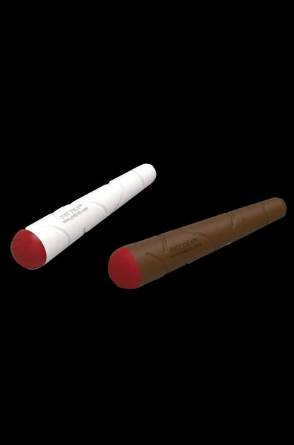 Diagonal close-up of two Puff Palz Doggie Doob Dog Toy sticks, one brown and one white, tipped with red caps against a black background