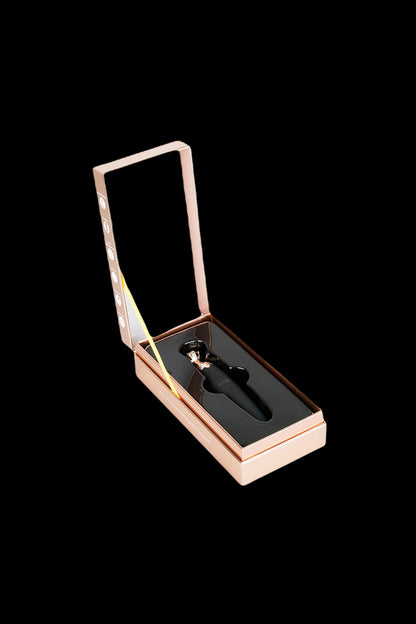 Luxury cannabis oil applicator in rose gold packaging.