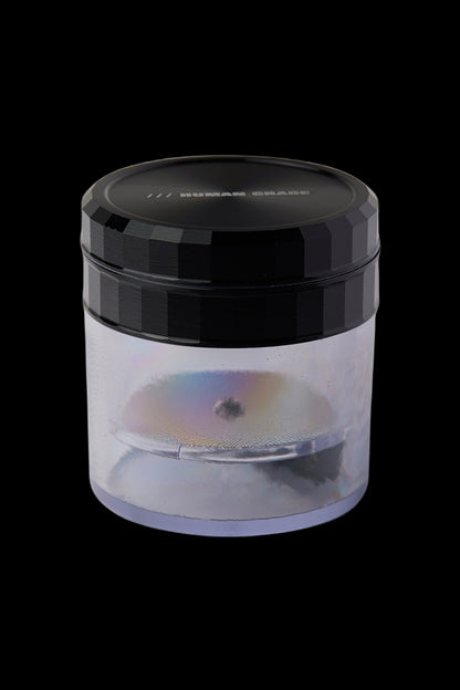 Iridescent cannabis grinder with a clear chamber showcasing ground flower.