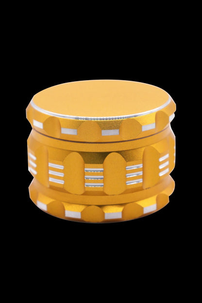 Gold cannabis grinder with white accent bands.