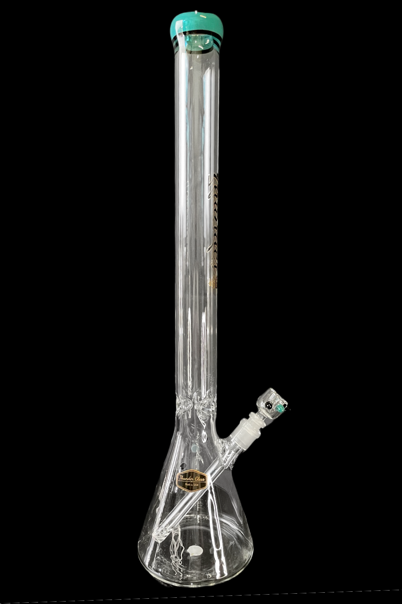 Clear glass bong with green accents, isolated on a black background.