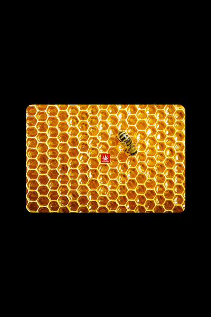 Honeycomb patterned cannabis rolling tray with a bee.