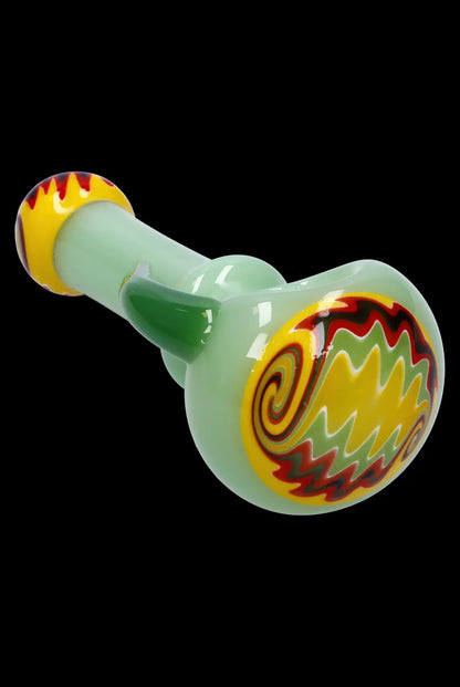 Green glass pipe with red and yellow swirl designs.