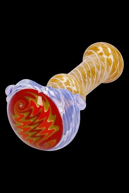 Hand-blown glass pipe with red and gold swirling patterns.