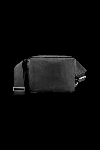 Black cannabis accessories bag with a shoulder strap on a dark background.