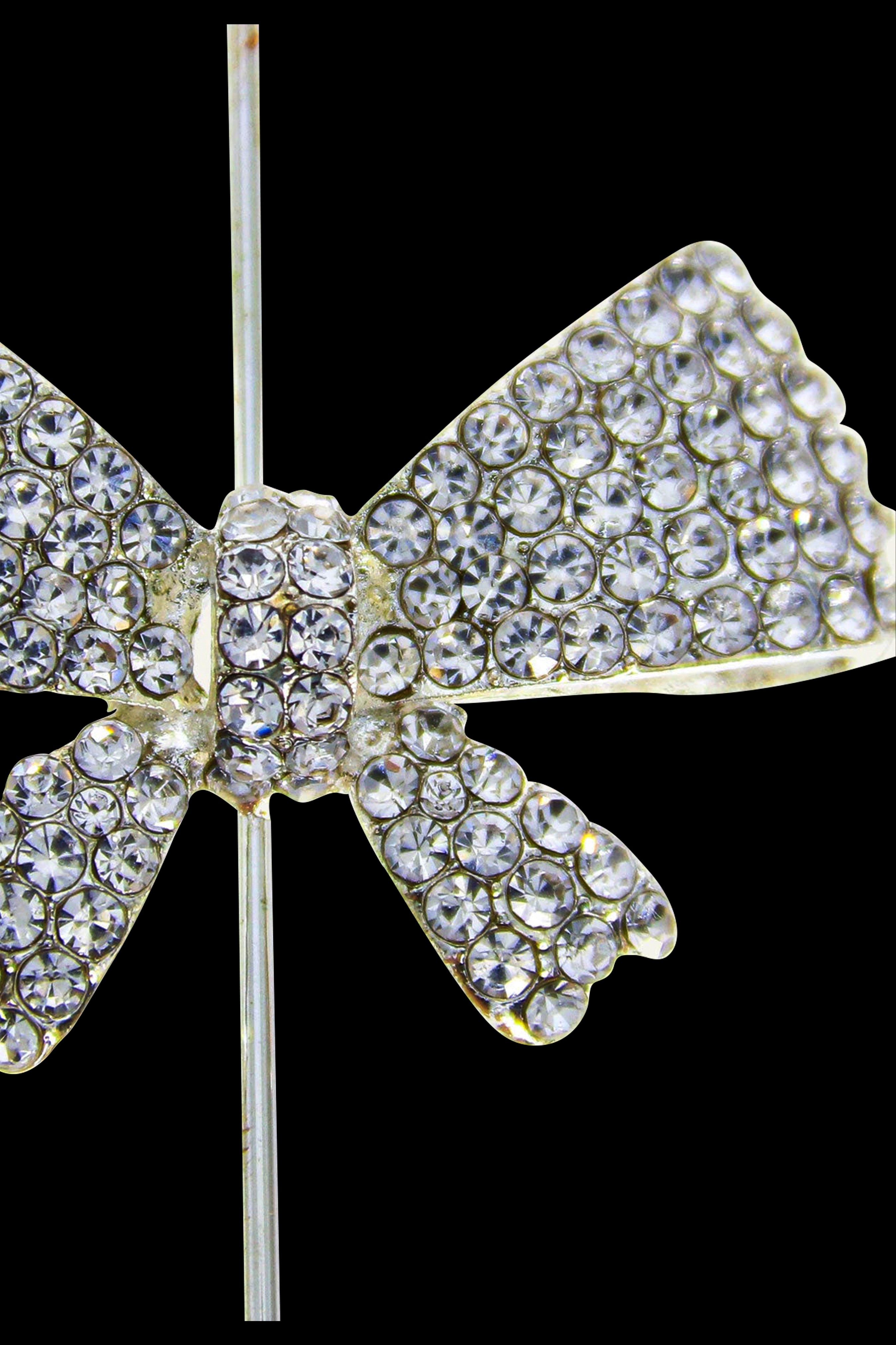 Sparkling, rhinestone-covered cannabis flower-shaped accessory on a metal stem against a black background.