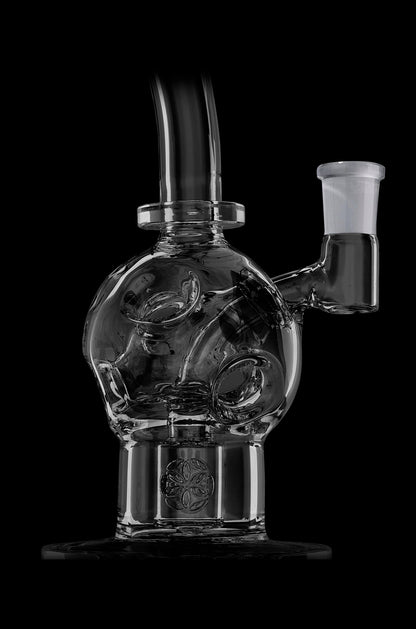 Clear glass water pipe (bubbler) with intricate swirling design and etched floral base, isolated on black.