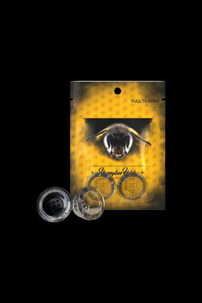 Close-up of the Honeybee Herb Glass Pipe Screens - 2 Pack packaging with a bee illustration on yellow background and three clear metal screens visible.