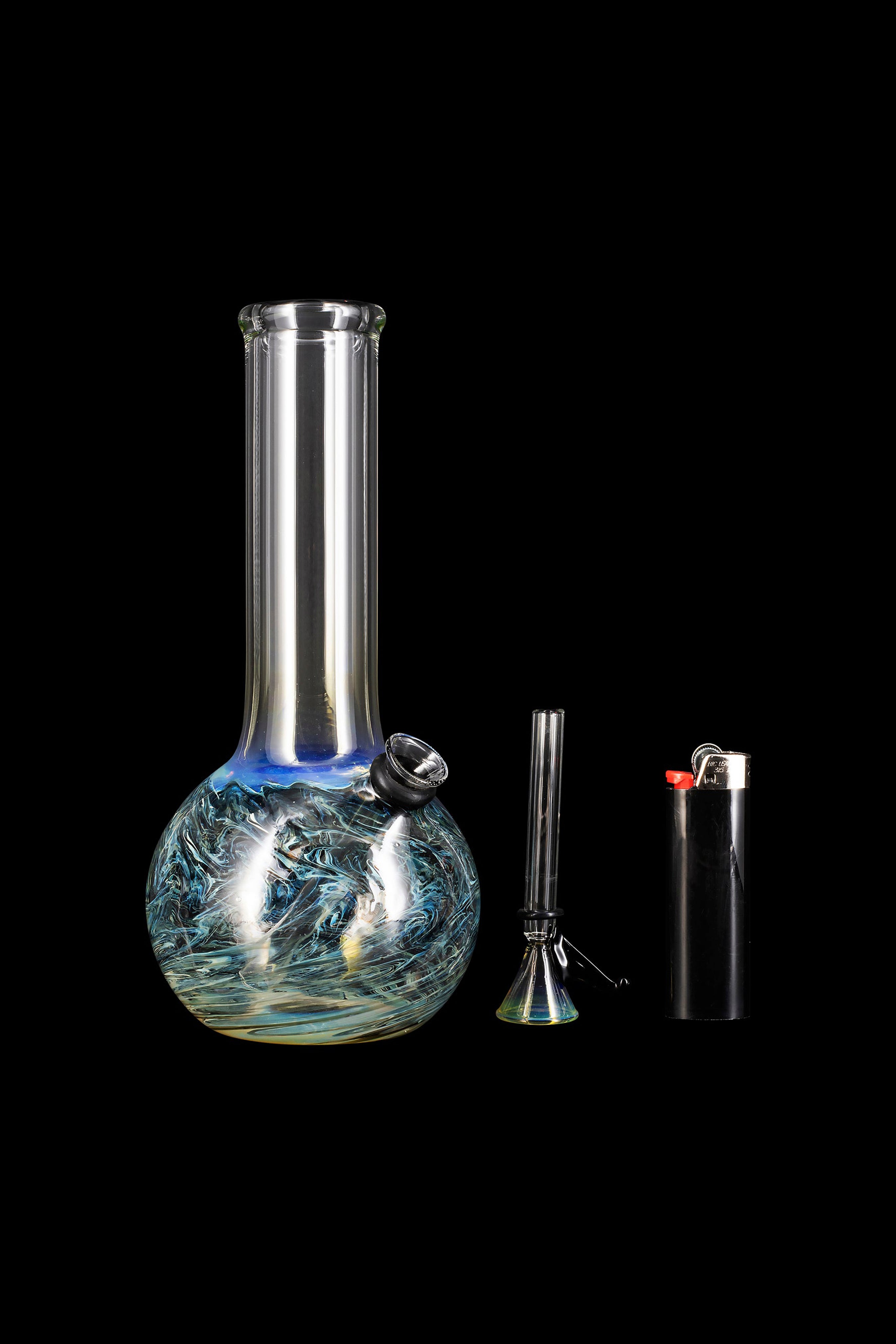 Glass water pipe (bong) with downstem and lighter on black background.