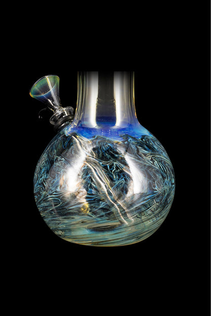 Blue and white glass water pipe with swirling patterns, isolated on a black background.