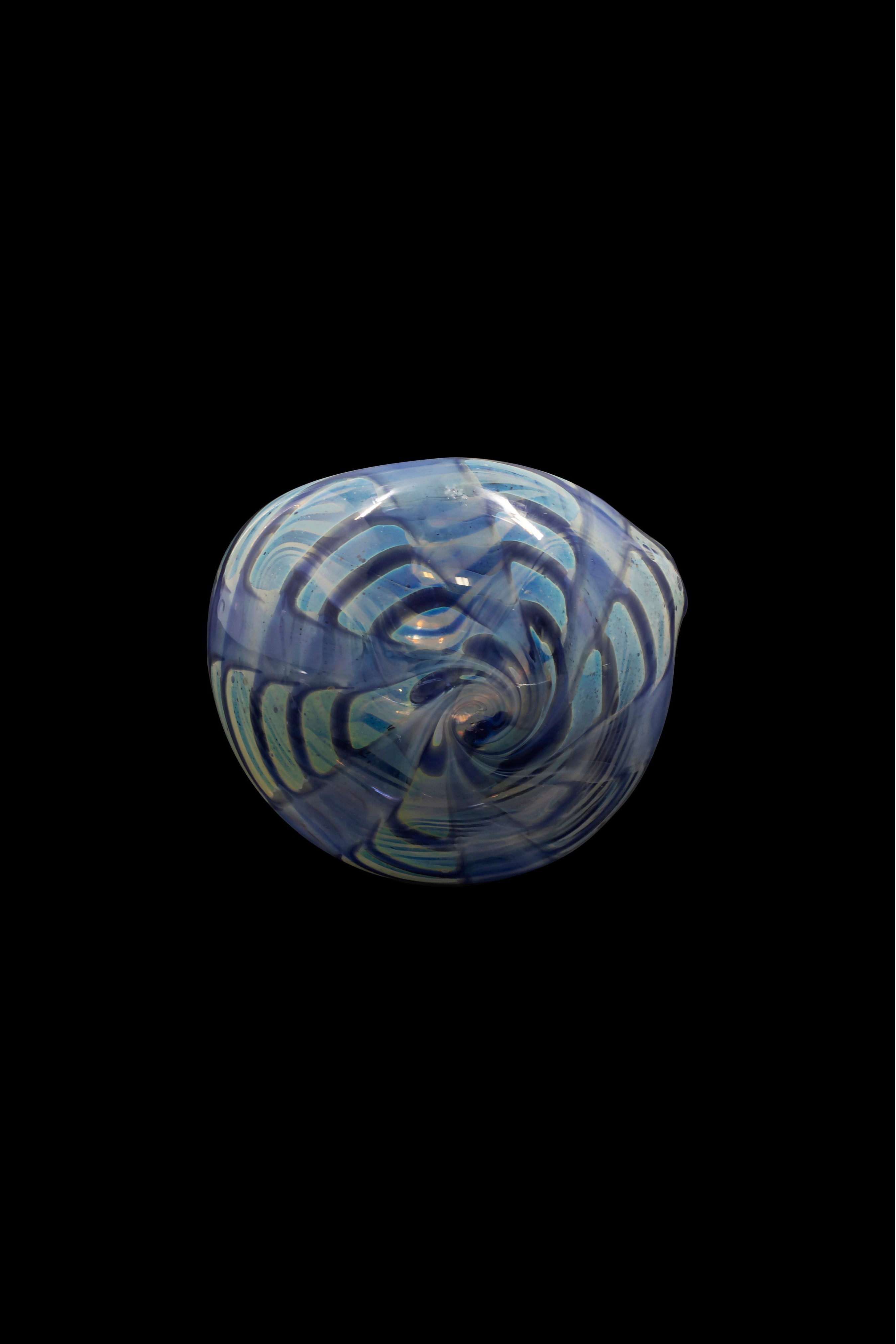 Blue and white swirled glass cannabis bowl against a black background.